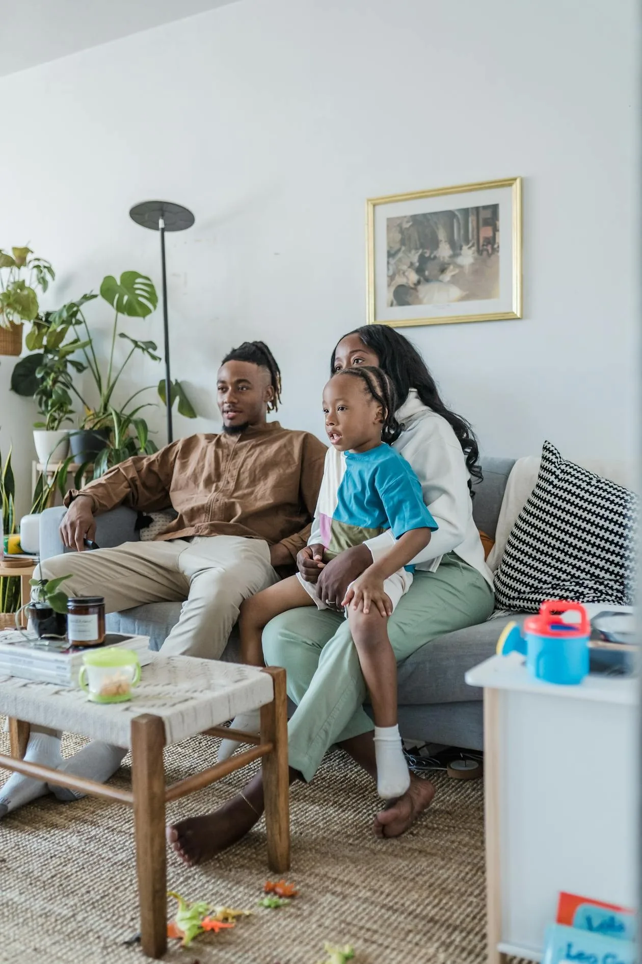 Family watching live sports on a large TV in a living room